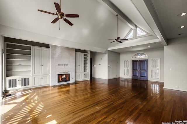 unfurnished living room featuring hardwood / wood-style flooring, a fireplace, baseboards, and beam ceiling