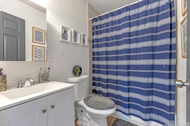 full bath featuring a textured wall, toilet, curtained shower, a textured ceiling, and vanity