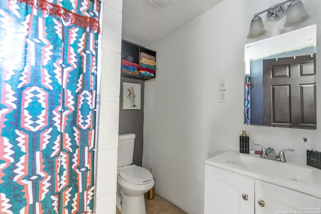 full bath with tile patterned flooring, vanity, and toilet