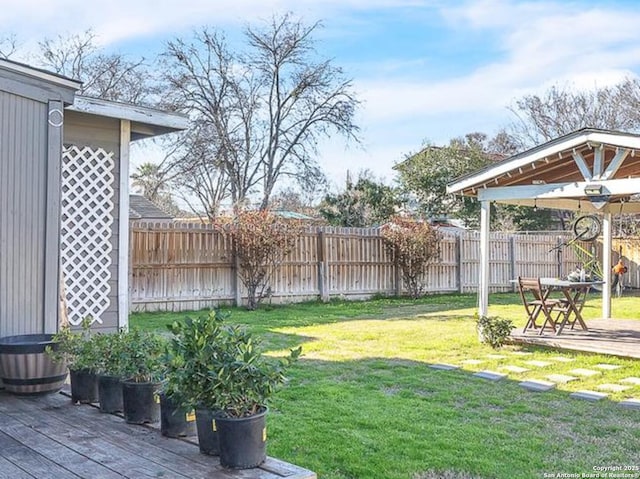 view of yard featuring a gazebo, fence, and a wooden deck