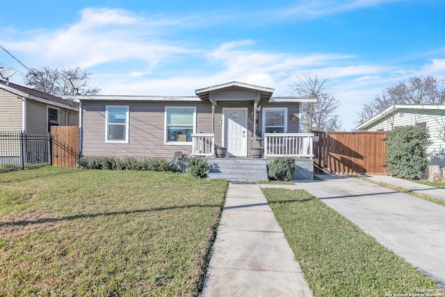 bungalow-style house featuring a gate, fence, a porch, and a front yard