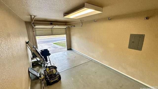915 Ridingate Farm, San Antonio, TX 78228 - garage with a textured wall, electric panel, and baseboards