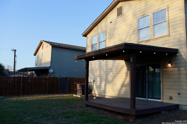 915 Ridingate Farm, San Antonio, TX 78228 - back of house with a deck, a lawn, and fence