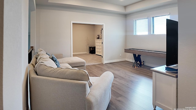 living area featuring wood finished floors and baseboards