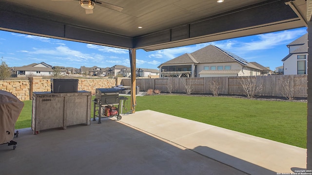 view of patio featuring a residential view, a fenced backyard, ceiling fan, and area for grilling