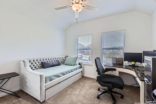 home office featuring lofted ceiling, ceiling fan, carpet, and baseboards