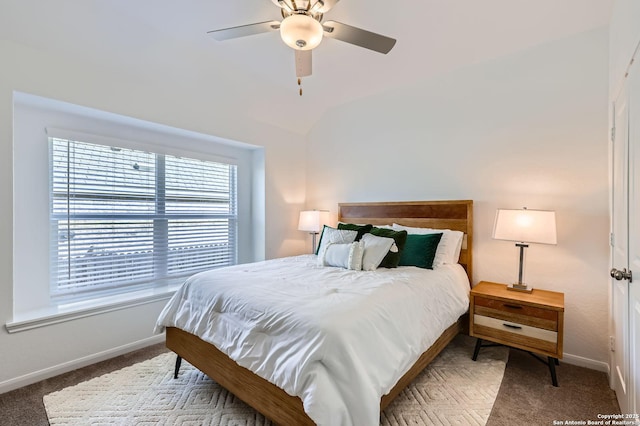 carpeted bedroom with lofted ceiling, ceiling fan, and baseboards