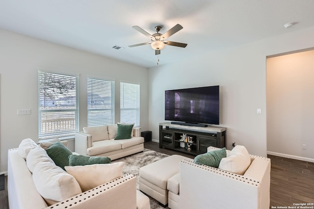 living area featuring ceiling fan, wood finished floors, visible vents, and baseboards