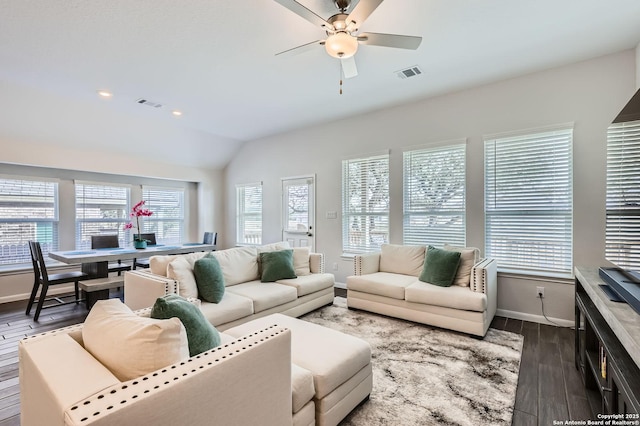 living area with lofted ceiling, dark wood-style flooring, visible vents, and baseboards