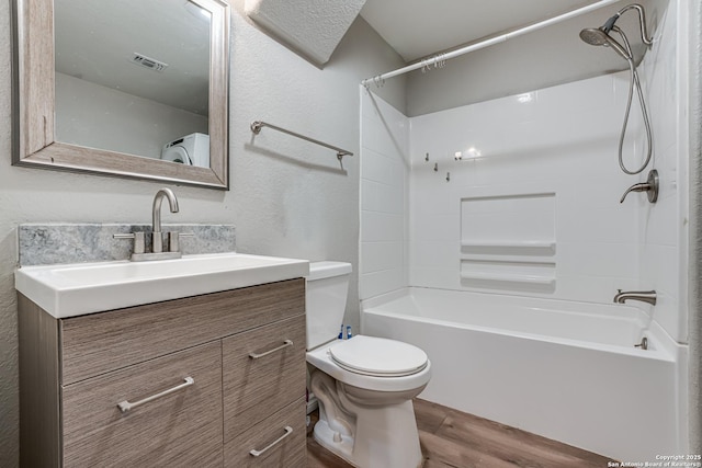 bathroom with tub / shower combination, vanity, toilet, and wood finished floors