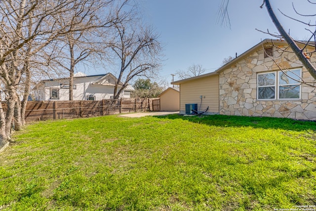 view of yard with a patio area, a fenced backyard, and central air condition unit