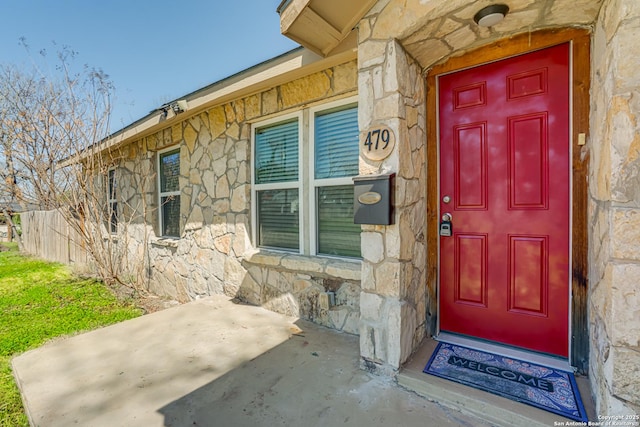 entrance to property featuring stone siding