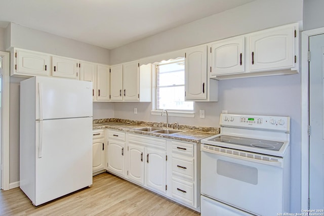 kitchen featuring white appliances, white cabinetry, and a sink