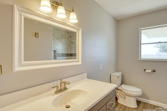 full bathroom featuring baseboards, vanity, toilet, and wood finished floors