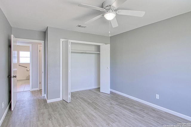 unfurnished bedroom with a ceiling fan, baseboards, visible vents, light wood-style floors, and a closet