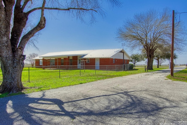 view of front of property with an outbuilding and metal roof