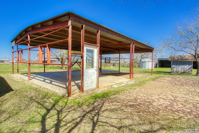 view of patio / terrace featuring a carport and an outdoor structure