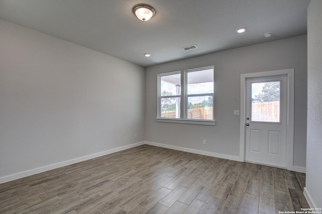 entrance foyer with plenty of natural light, wood finished floors, visible vents, and baseboards