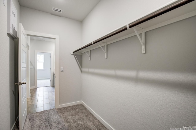 spacious closet featuring carpet floors and visible vents