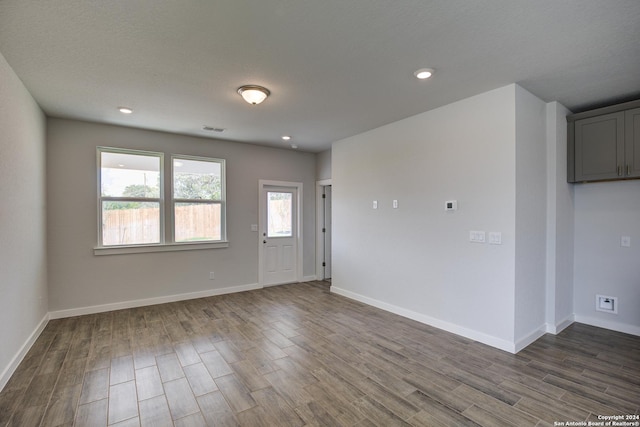 unfurnished room with dark wood-style floors, recessed lighting, visible vents, and baseboards