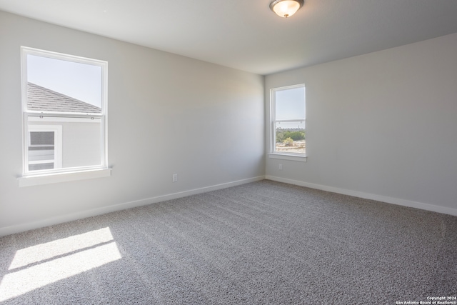 carpeted spare room with baseboards