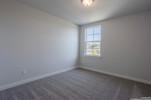 empty room with carpet floors and baseboards