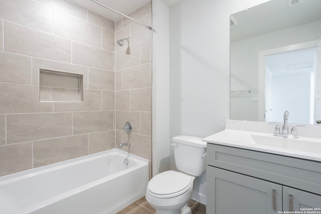 full bathroom featuring toilet, wood finished floors, vanity, and bathing tub / shower combination