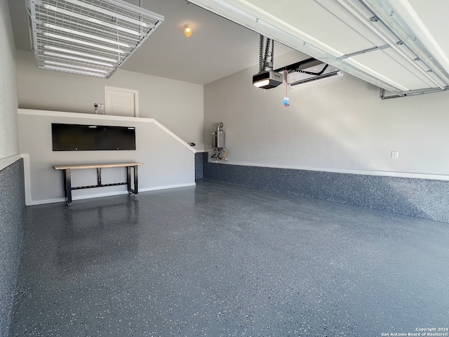 garage featuring baseboards and a garage door opener