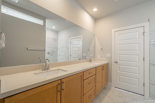 full bathroom featuring double vanity, marble finish floor, a sink, and recessed lighting