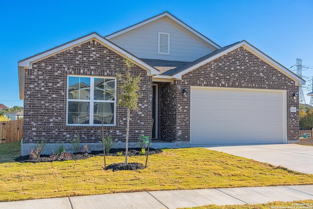 view of front facade featuring an attached garage, brick siding, fence, driveway, and a front yard