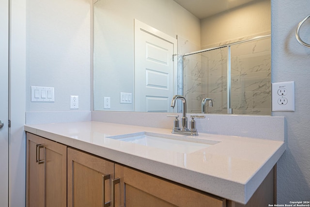 bathroom with a textured wall and vanity