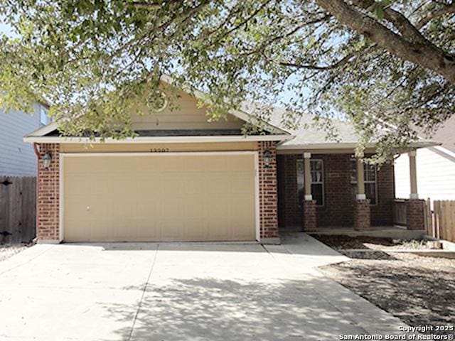 single story home with driveway, a garage, fence, and brick siding