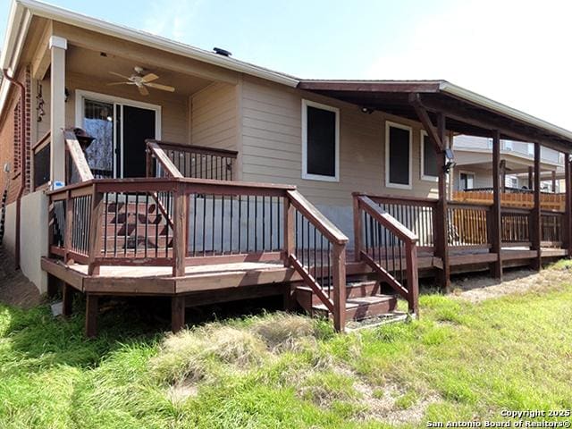 back of house with ceiling fan and a deck