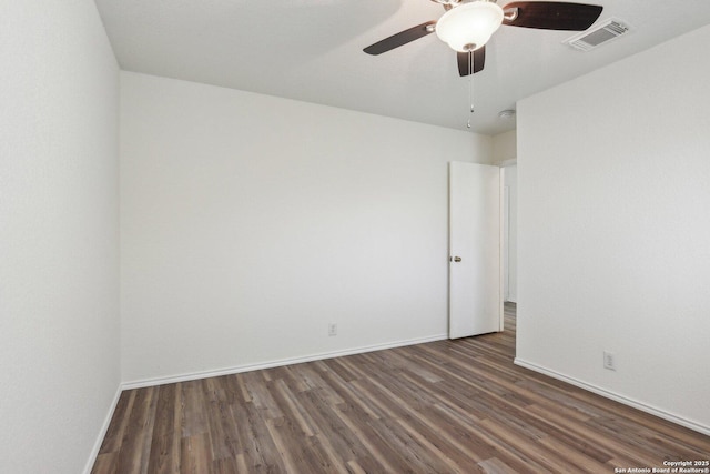 unfurnished room with a ceiling fan, wood finished floors, visible vents, and baseboards