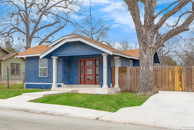 view of front of home featuring fence and brick siding