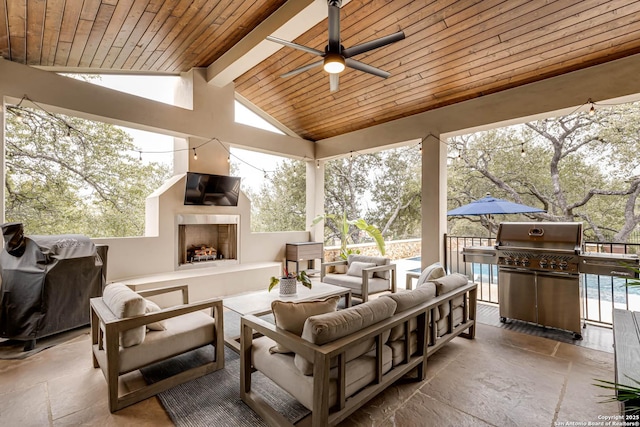 view of patio / terrace featuring a grill, an outdoor living space with a fireplace, and ceiling fan