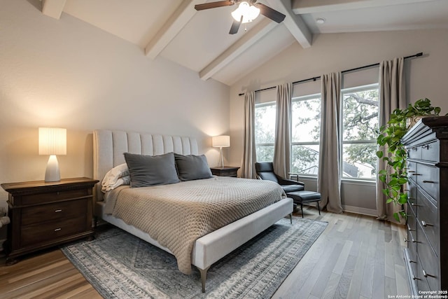 bedroom featuring lofted ceiling with beams, light wood-style flooring, baseboards, and ceiling fan