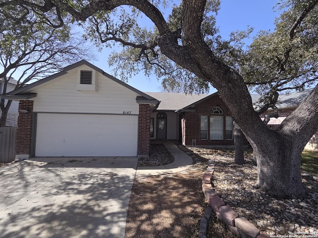 ranch-style home featuring an attached garage, concrete driveway, and brick siding