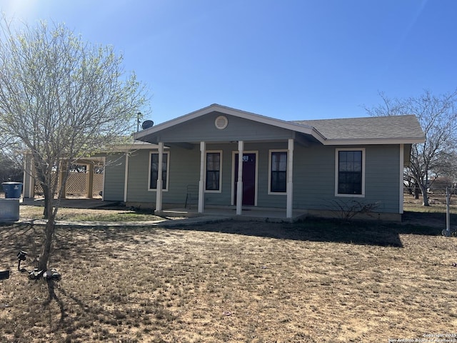 view of front of property featuring covered porch and roof with shingles