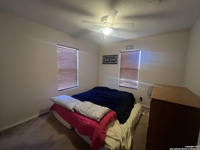 bedroom featuring a ceiling fan, carpet flooring, a textured ceiling, and baseboards