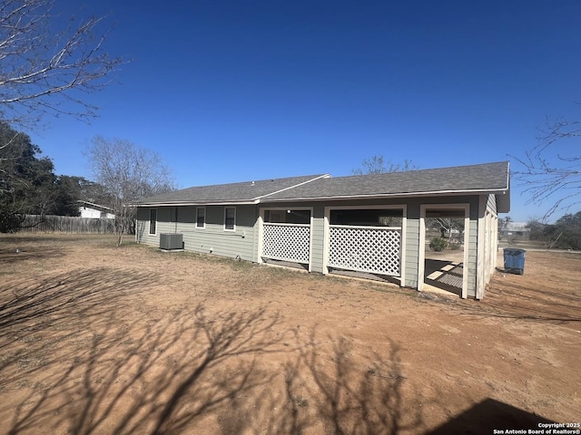 view of front of property featuring cooling unit and fence