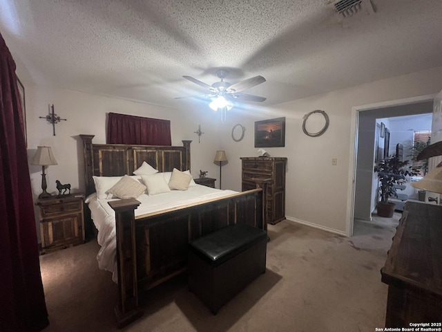 carpeted bedroom with a ceiling fan, visible vents, a textured ceiling, and baseboards