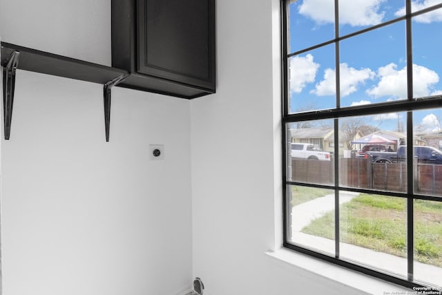 laundry area with cabinet space and electric dryer hookup