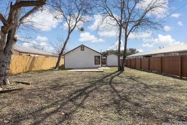 view of yard featuring an outdoor structure and a fenced backyard