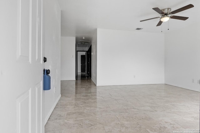 spare room featuring visible vents and ceiling fan