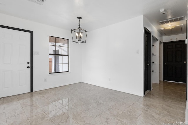 unfurnished dining area featuring an inviting chandelier, visible vents, and attic access