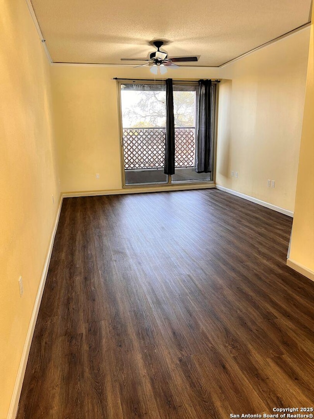 unfurnished room with dark wood-type flooring, ceiling fan, a textured ceiling, and baseboards