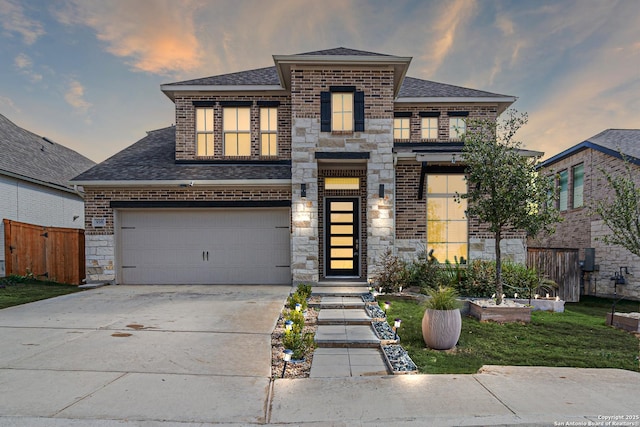 view of front of house featuring stone siding, concrete driveway, and brick siding