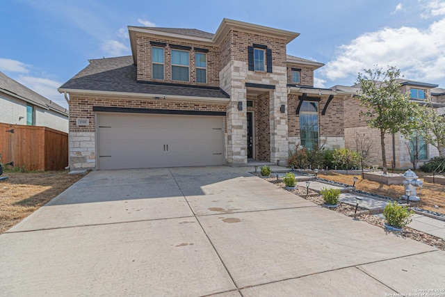 view of front of property featuring driveway, stone siding, roof with shingles, an attached garage, and brick siding