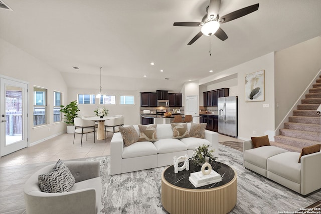 living area featuring ceiling fan, stairway, plenty of natural light, and recessed lighting